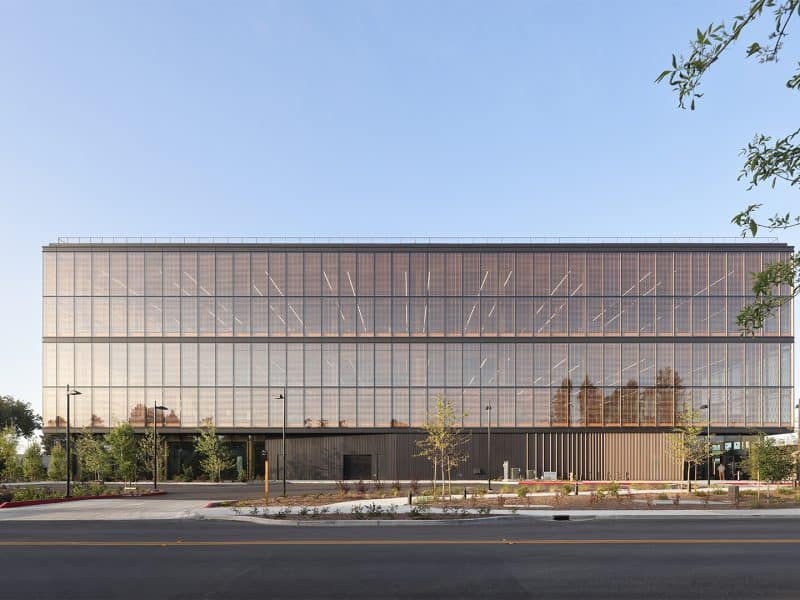 Google Borregas building exterior featuring a custom blackened steel finish with box rib formed panels by Pure + FreeForm on the canopy and soffit, creating a sleek, modern look.