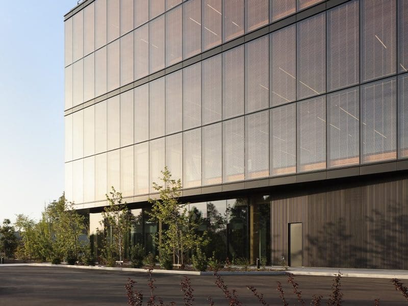 Google Borregas building exterior featuring a custom blackened steel finish with box rib formed panels by Pure + FreeForm on the canopy and soffit, creating a sleek, modern look.