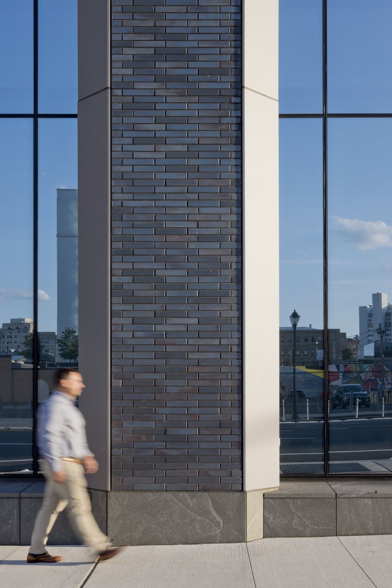 Column covers at 2222 Market Street in Philadelphia, featuring Pure + FreeForm's silver Frozen Hairline metal finish, showcasing a sleek, frosted texture that enhances the building’s modern architectural design.